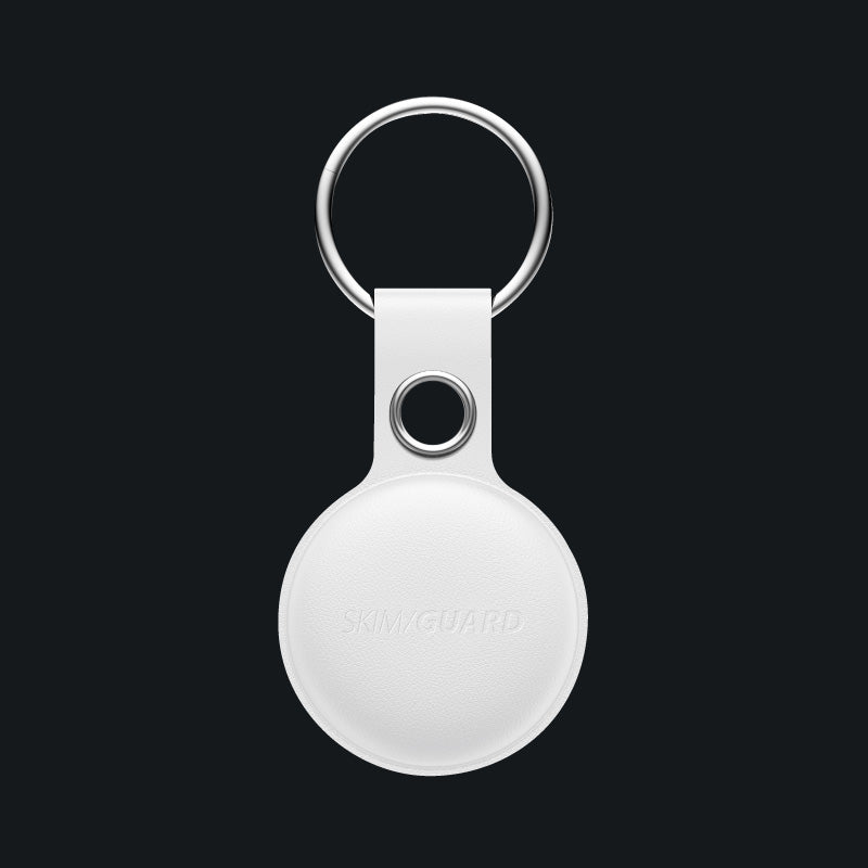 White Skimguard Travel Traka inside a white leather keyring case.
